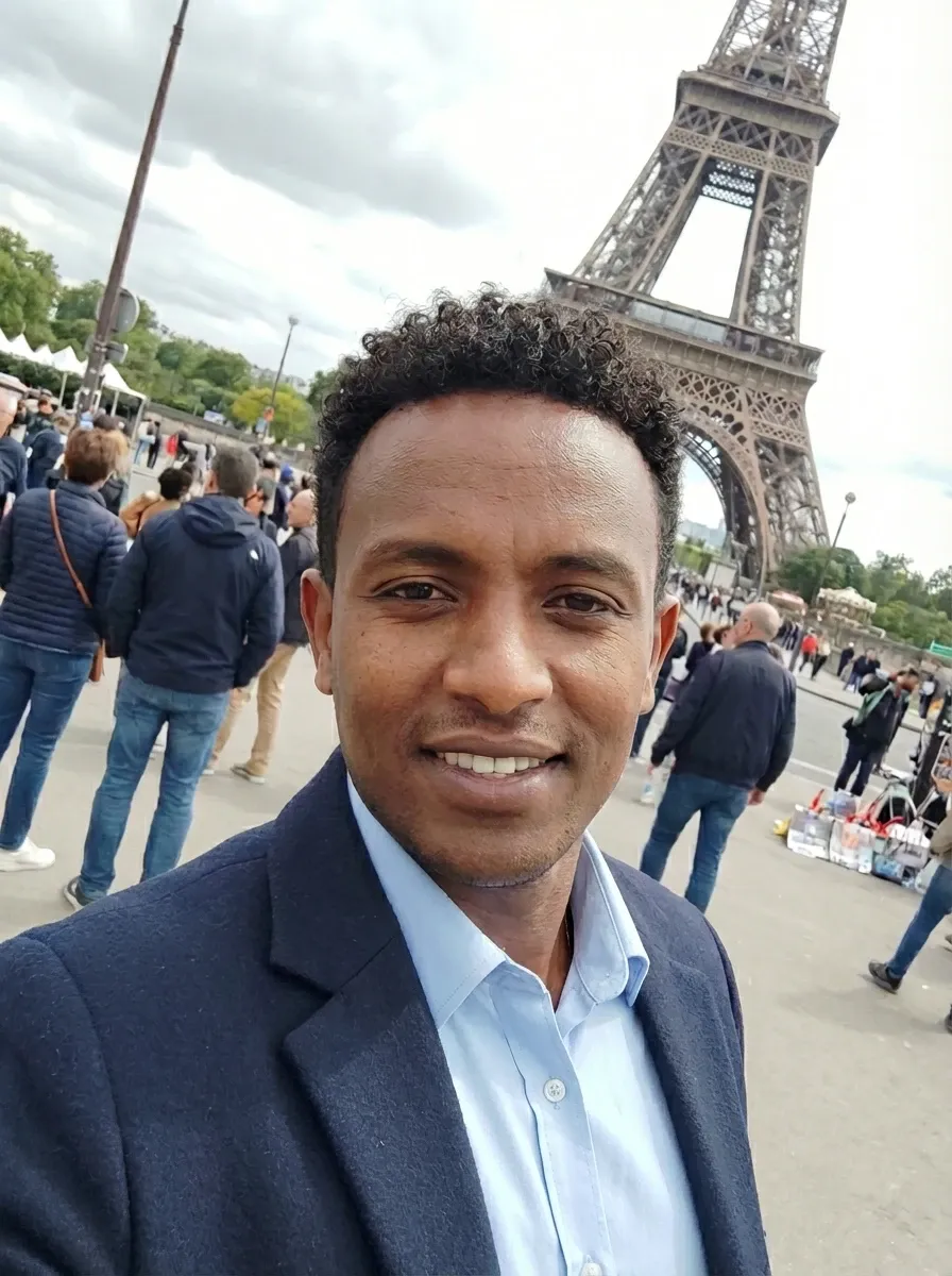 Original selfie input — smiling man in a blazer on a travel trip